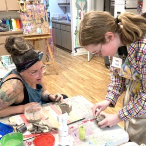 Ms. Heidi instructs a ceramics lesson